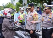 Cara Ditlantas Polda Sultra Edukasi Warga: Bagi Bunga dan Helm di Jalan Protokol Kendari